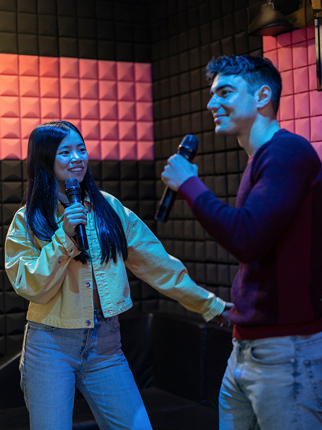 Topdeck travellers singing Karaoke together.